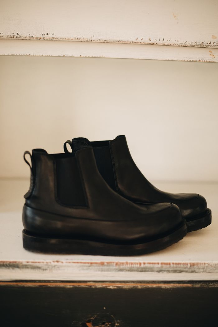 Elegant black leather Chelsea boots showcasing minimalist design and craftsmanship.